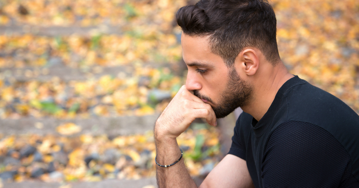 man pensive sad wondering outdoors